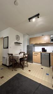 a kitchen with a table and chairs in a room at Le 61 Roosvelt in Amiens +6 photos