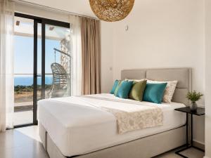 a bedroom with a bed with a view of the ocean at Esentepe Collection Nothern Cyprus Villas & Apartments with Sea View Nothern Cyprus in Pallouriotissa +174 photos