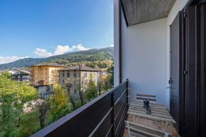 a balcony with a bench and a view of a city at Vista piste da sci - Aprica Centro - Piste a 2 min, Wifi in Aprica