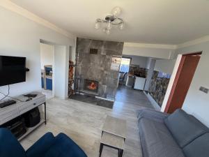 a living room with a couch and a fireplace at Szlachcianka in Gorzuchów