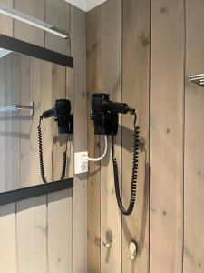 a phone hanging on a wall in a bathroom at Large cabin with panoramic wiews in Ål, Hallingdal in Al +51 photos