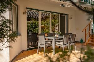 a dining room with a table and chairs on a patio at Ferienstudio Traunsee in Gmunden +13 photos