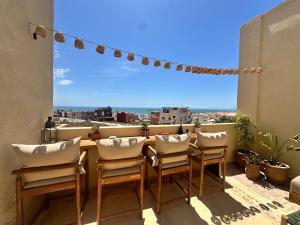 a balcony with chairs and a table with a view at Arya Imsouane in Imsouane +61 photos