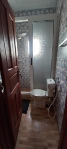 a bathroom with a toilet and a walk in shower at Résidence Diamant in Bamako