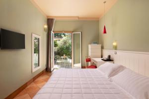 a bedroom with a large white bed and a desk at Marin Hotel in Pula
