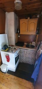 a small kitchen with a stove and a sink at Chata Tatrovice in Tatrovice