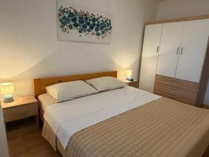 a bedroom with a large bed and two night stands at Apartment Hramina in Murter +44 photos