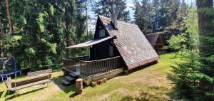 a small cabin in the middle of a forest at Chata Tatrovice in Tatrovice +9 photos
