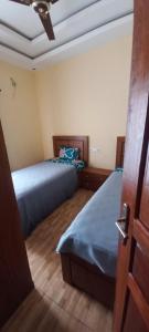 a bedroom with two beds and a ceiling at Résidence Diamant in Bamako