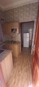 an empty kitchen with a sink and a refrigerator at Résidence Diamant in Bamako