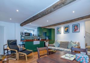 a living room with a couch and a table at Cottage on Wells High Street in Wells