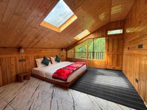 a bedroom with a bed in a wooden room at Venky's Shoja in Jibhi