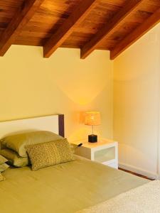 a bedroom with a bed and a table with a lamp at Ribeira da Janela Paradise View in Porto Moniz
