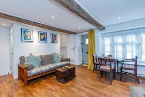 a living room with a couch and a table at Cottage on Wells High Street in Wells