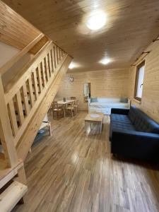 a living room with a couch and a staircase at Komorník Residence 14 in Kunžak