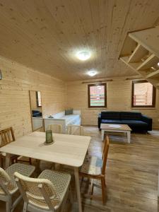 a living room with a table and a couch at Komorník Residence 14 in Kunžak