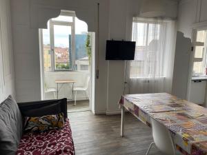 a living room with a table and a couch at Rachana Guest House in Mestre