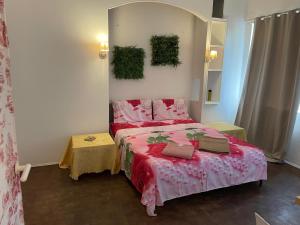 a bedroom with a bed with a red comforter at Rachana Guest House in Mestre