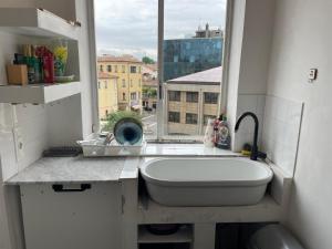 a bathroom with a sink and a window at Rachana Guest House in Mestre +25 photos