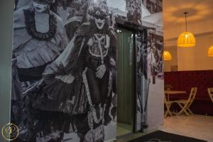 a mural of two skeletons on a wall at OR HOTEL 94 in Barranquilla +27 photos