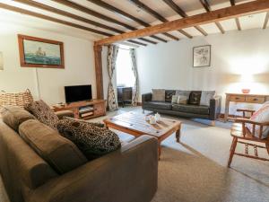 a living room with a couch and a table at Dewi Villa in Aberaeron