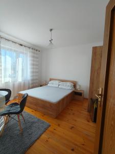 a bedroom with a bed and a chair in it at Agroturystyka Krzywy Zakątek in Krzywe