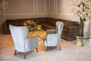 a living room with a couch and two chairs and a table at OR HOTEL 94 in Barranquilla
