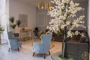 a living room with a couch and a table with a tree at OR HOTEL 94 in Barranquilla
