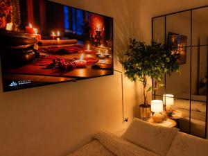 a living room with a tv hanging on the wall at SOL LUX Tuzla in Tuzla