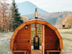 a small wooden building with a bottle of wine at Čiles in Kostolec +18 photos