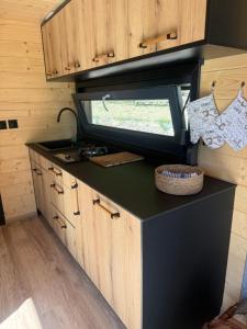 a kitchen in a tiny house with a counter top at Čiles in Kostolec