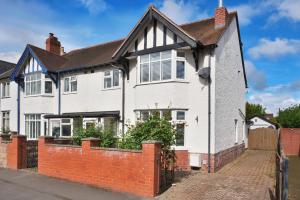 a white house with a red brick fence at Spacious Free Parking 5 Mins from City Centre in Hereford