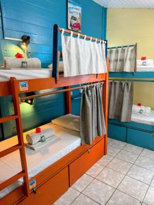 two bunk beds in a room with blue walls at Casa Swell Hostel in Fernando de Noronha