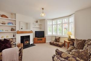 a living room with a fireplace and a tv at Spacious Free Parking 5 Mins from City Centre in Hereford