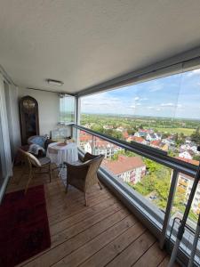 a large room with a balcony with a table and chairs at Helle Wohnung in Fürth in Fürth