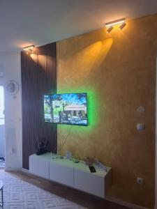 a living room with a tv on a wall at Apartman M&Ð Foca-free parking garage in Foča