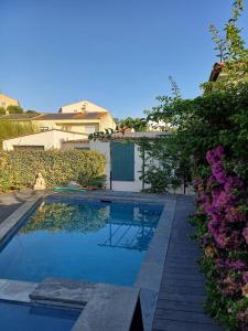 a swimming pool in front of a house at La dependance in Saint-Gilles