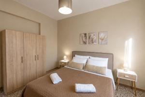 a bedroom with a bed with two towels on it at Villa Berlie in Keramiaí +37 photos