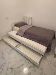 a bed in a room with a white bed frame at RK chic Apartments in Colombaro