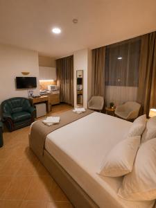 a bedroom with a large bed and a living room at Esprit Residences Budapest in Budapest