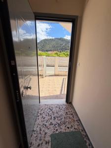 a door leading into a room with a view at Derveni Nest Apartment in Rodhéa