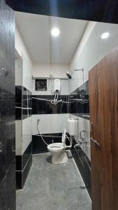 a bathroom with a toilet in a room at THE RAMA Executive in Tuljapur +17 photos