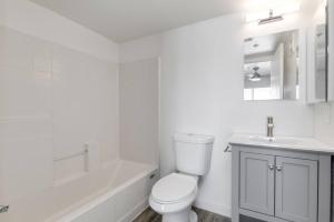 a white bathroom with a toilet and a sink at Close to ASU campus in Tempe +1 photo