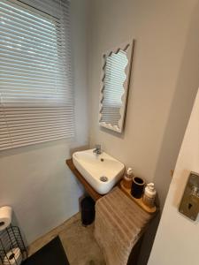 a bathroom with a sink and a mirror at Avo 1 on 27 Drew in Howick +16 photos