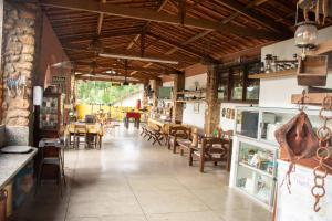 a restaurant with tables and chairs in a room at Chalés de Triunfo in Triunfo