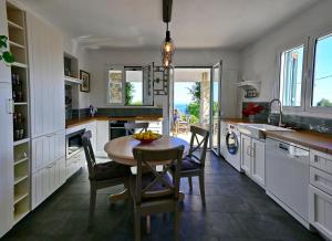 a kitchen with a table and chairs and a sink at Agrielia House in Alonnisos