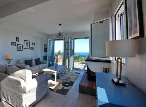 a living room with a couch and a table at Agrielia House in Alonnisos