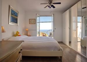 a bedroom with a bed with a view of the ocean at Agrielia House in Alonnisos