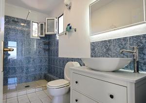 a bathroom with a sink and a toilet and a shower at Agrielia House in Alonnisos +24 photos