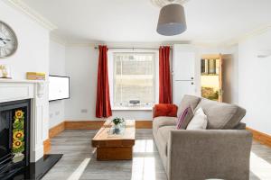 a living room with a couch and a fireplace at Central Basement Flat-Parking-By FabAccommodation in Bristol